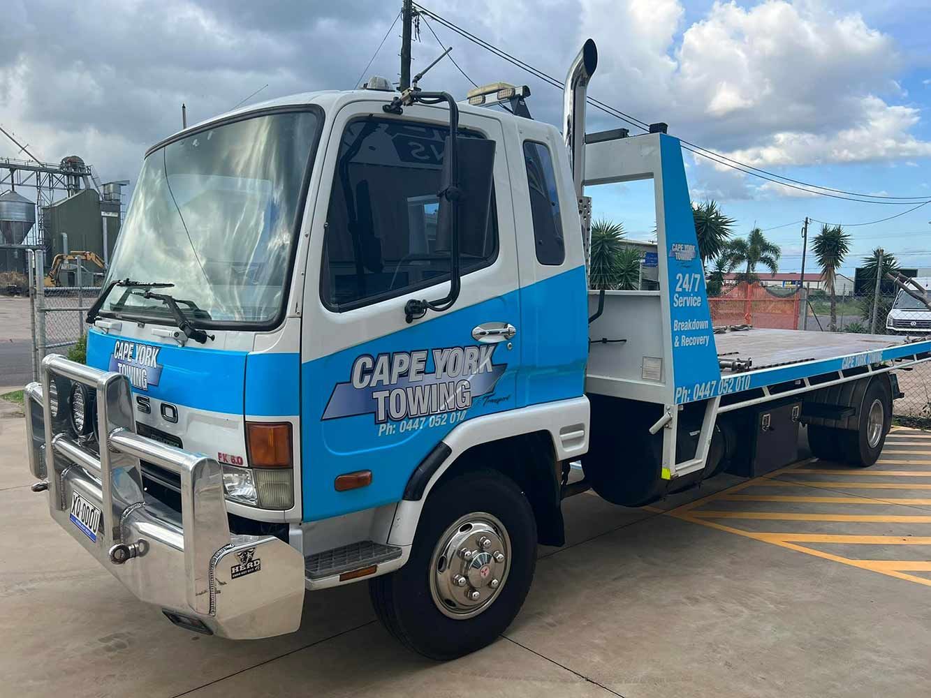 A Blue and White Tow Truck is Parked in a Parking Lot — Cape York Towing & Transport in Musgrave, QLD