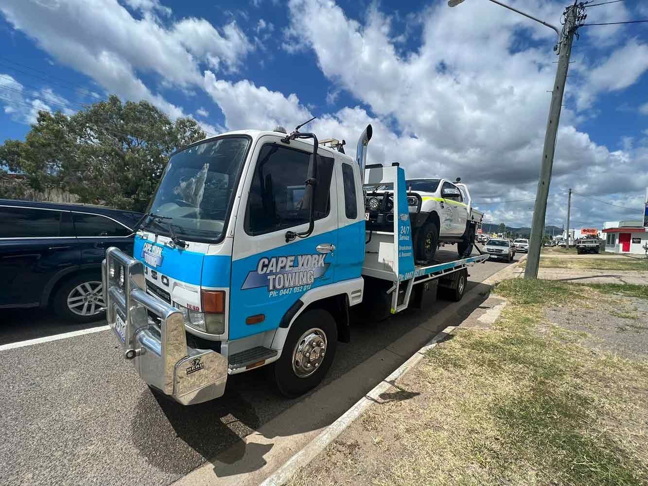 A Blue and White Tow Truck is Parked on the Side of the Road — Cape York Towing & Transport in Weipa, QLD