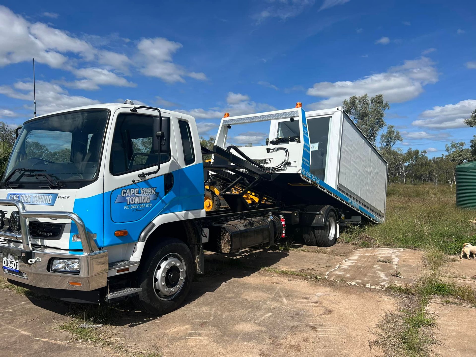 A Tow Truck With a Car on the Back is Parked on the Side of the Road — Cape York Towing & Transport in Lockhart River, QLD