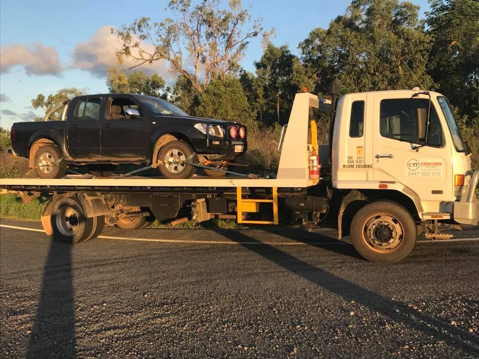 A Black Truck is Being Towed by a Tow Truck — Cape York Towing & Transport in Northern Peninsula Area, QLD