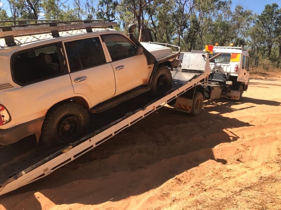 A White SUV is Being Towed by a Tow Truck — Cape York Towing & Transport in Pormpuraaw, QLD