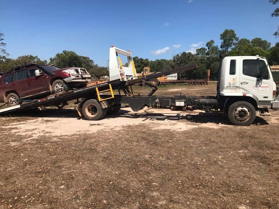 A Tow Truck is Towing a Car in a Field — Cape York Towing & Transport in Lockhart River, QLD