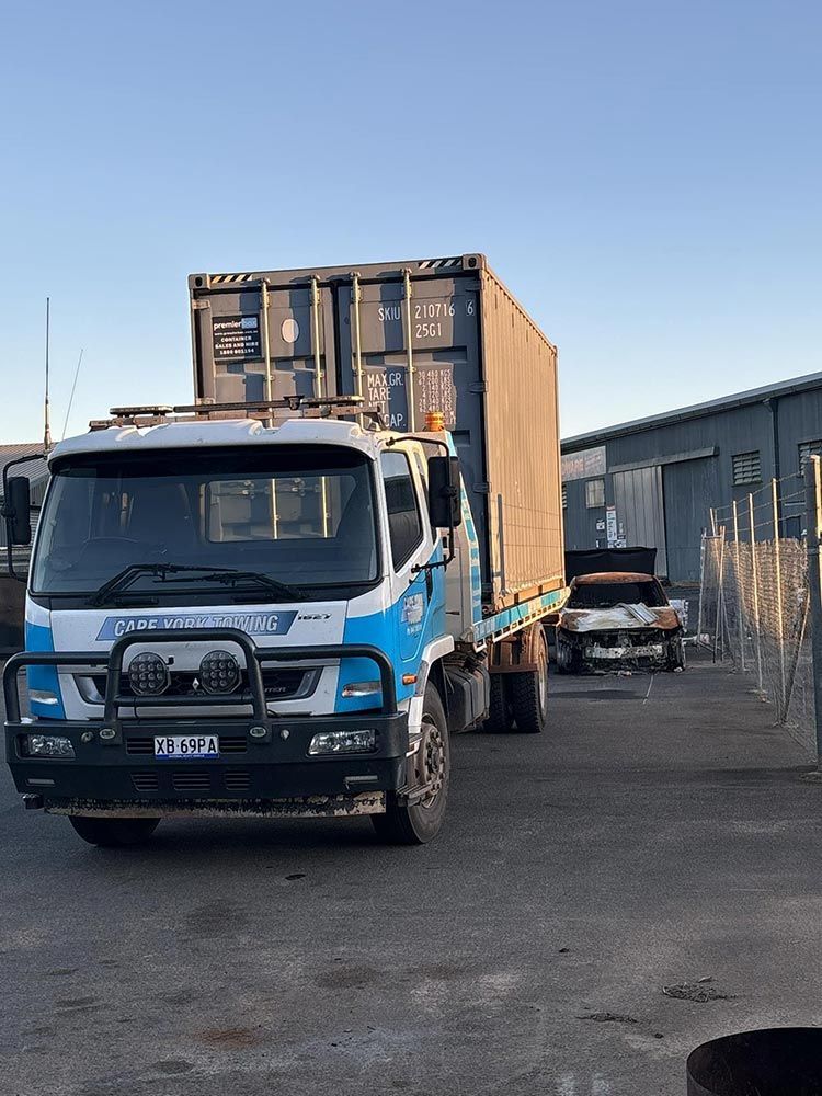 A Blue Truck With a Container on the Back is Parked in a Parking Lot — Cape York Towing & Transport in New South Wales, AUS