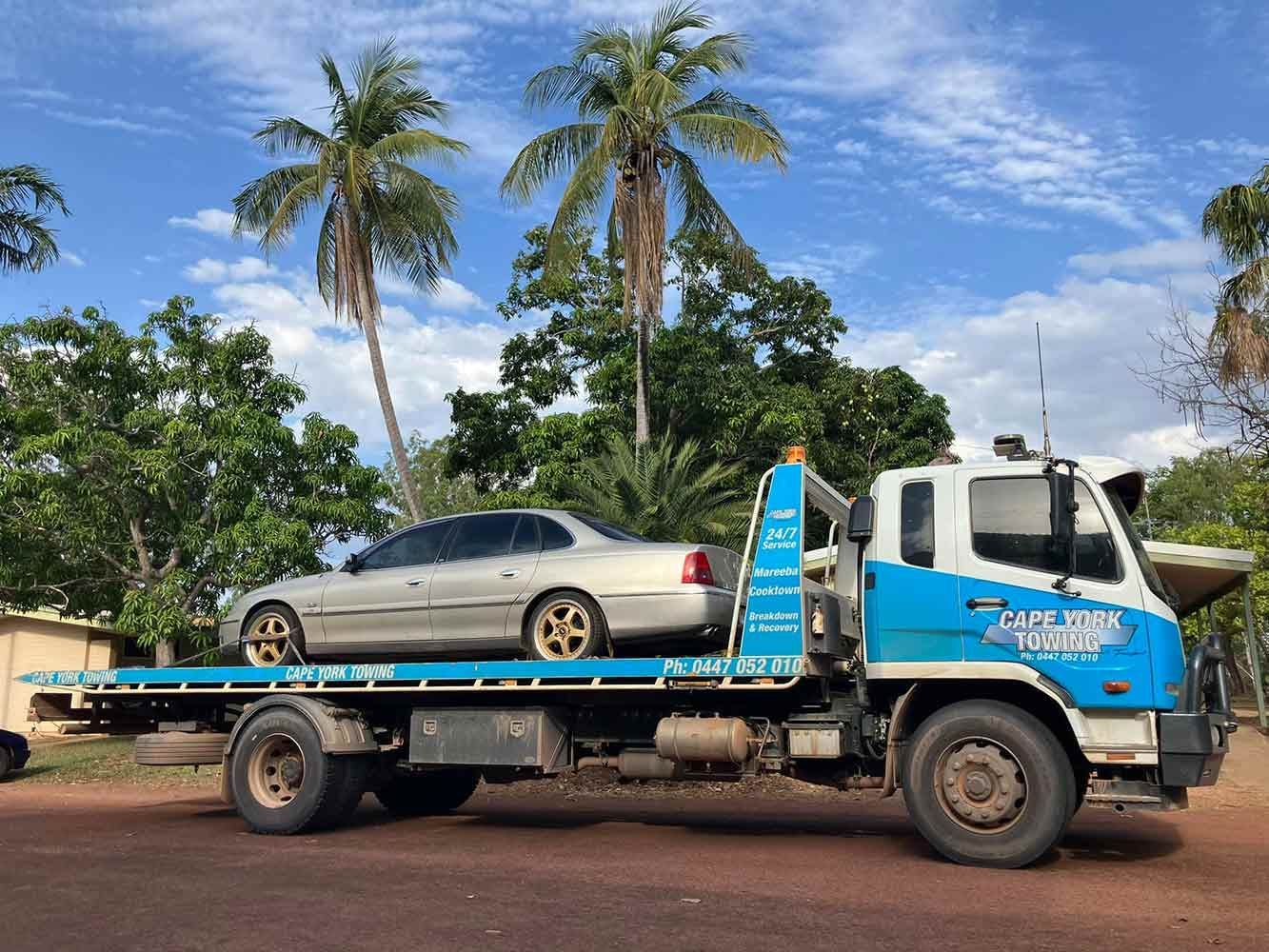 A Tow Truck With a Car on the Back of It — Cape York Towing & Transport in Brisbane, QLD