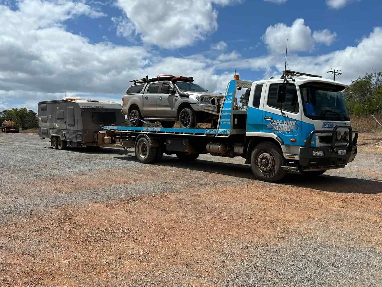 A Tow Truck is Carrying a Camper and a Truck — Cape York Towing & Transport in Musgrave, QLD