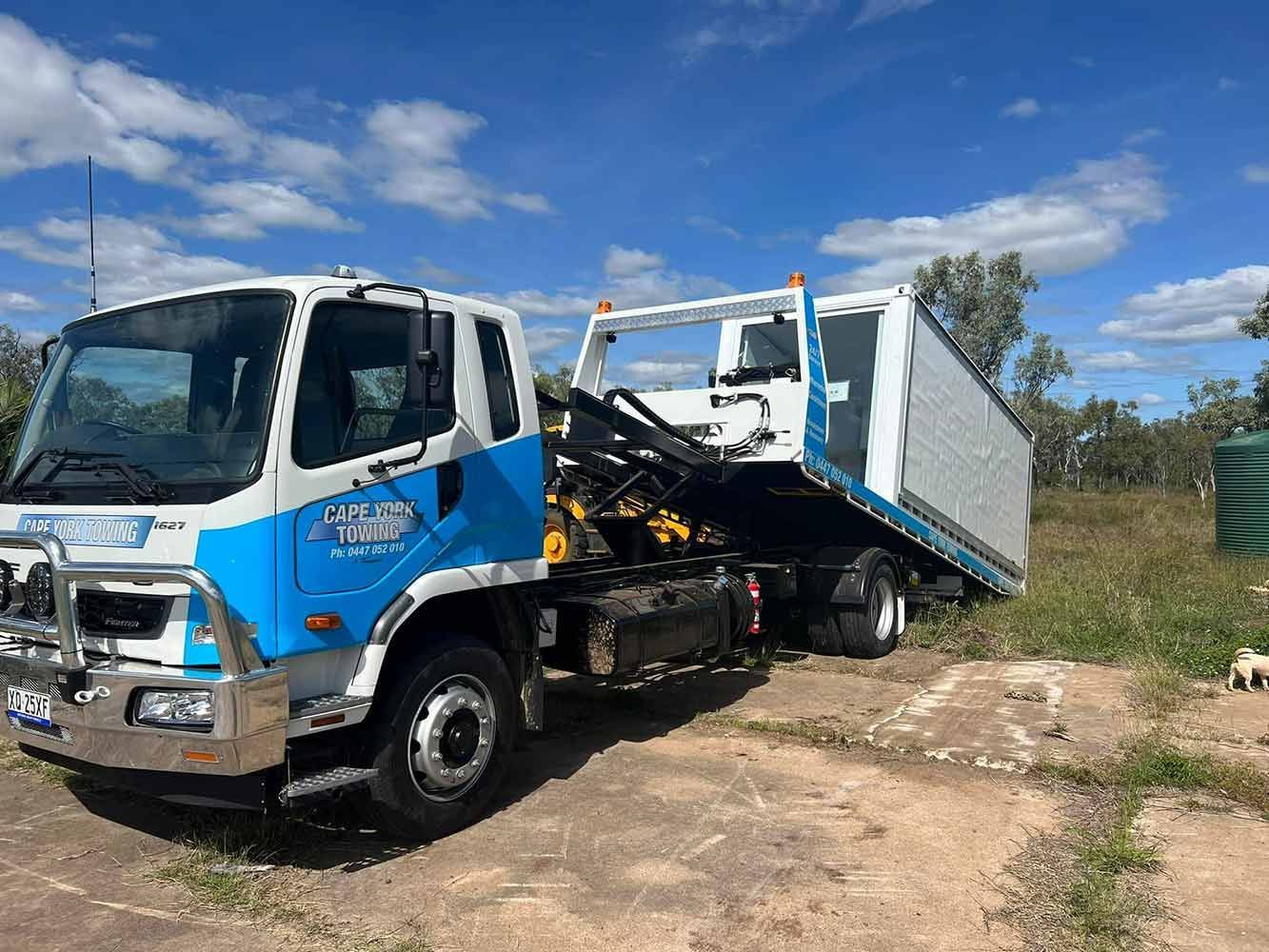 A Blue and White Tow Truck is Parked in a Field — Cape York Towing & Transport in Burketown, QLD