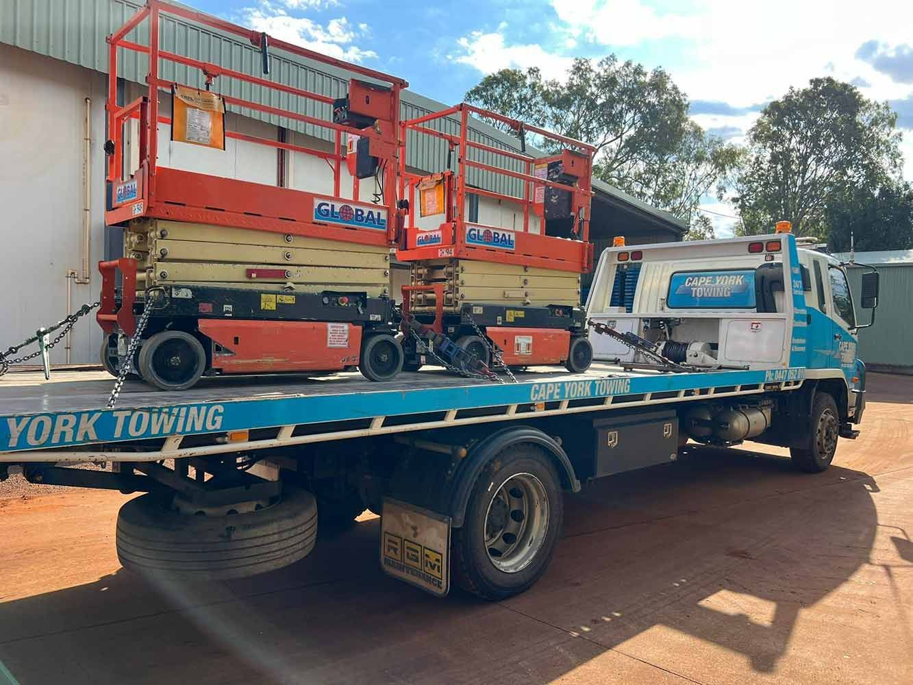 Two Scissor Lifts Are Sitting on Top of a Tow Truck — Cape York Towing & Transport in Karumba, QLD