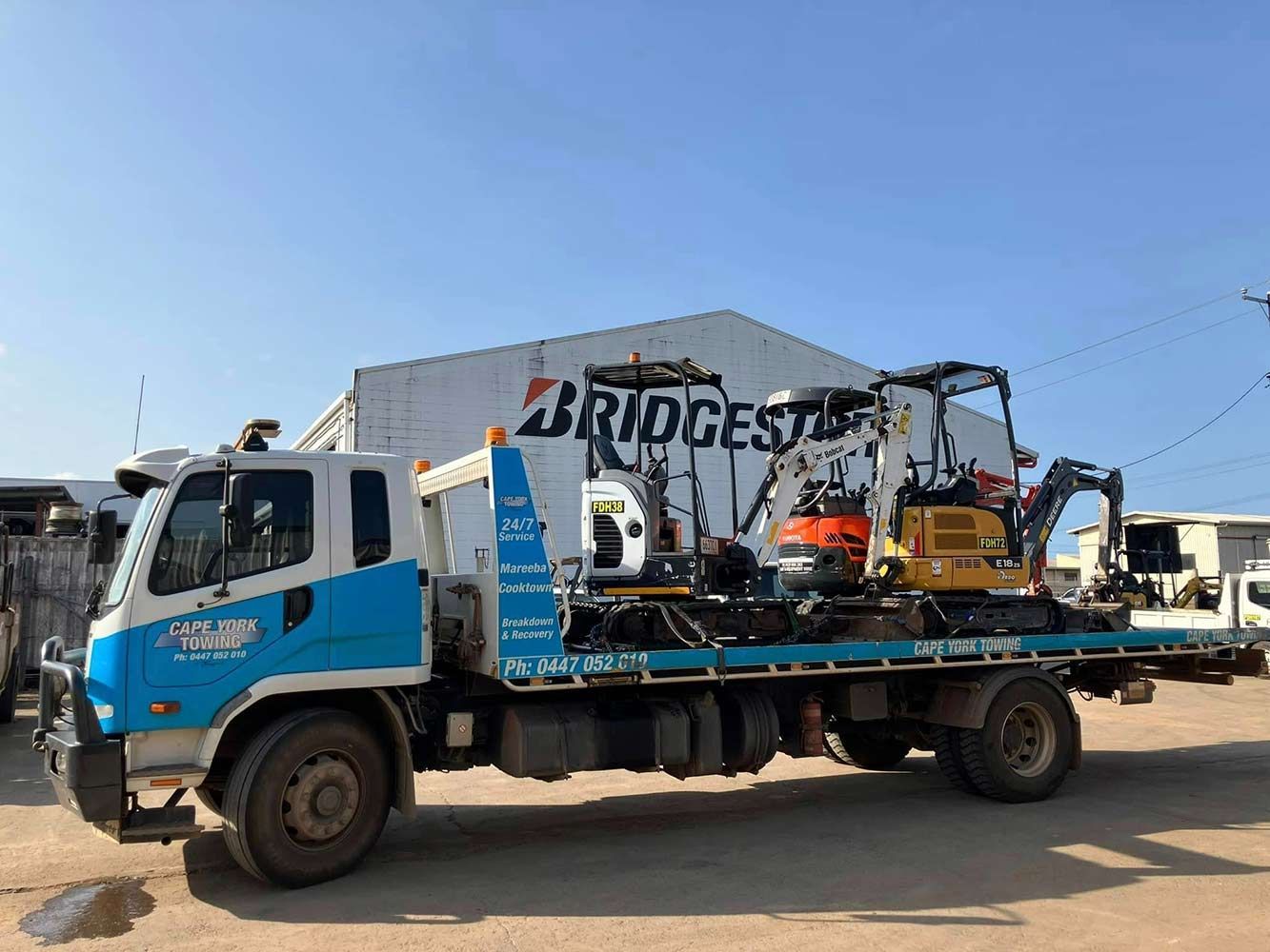 A Tow Truck is Parked in Front of a Bridgestone Building — Cape York Towing & Transport in Karumba, QLD