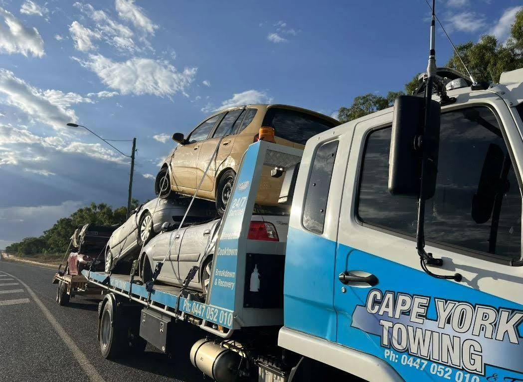 A Blue and White Tow Truck is Carrying Cars on the Back of It — Cape York Towing in Hann River, QLD