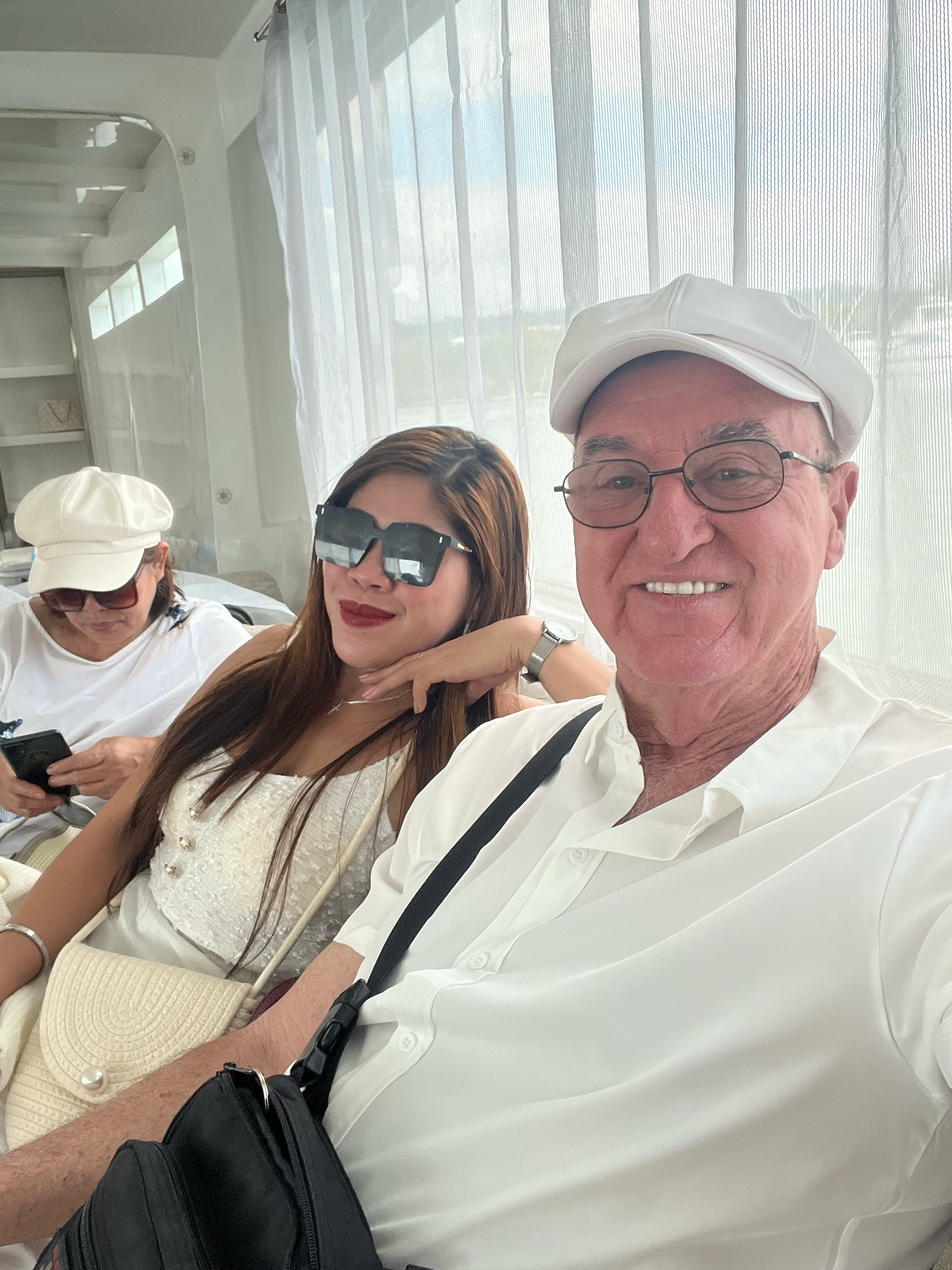 A man and a woman are sitting next to each other in front of a window.