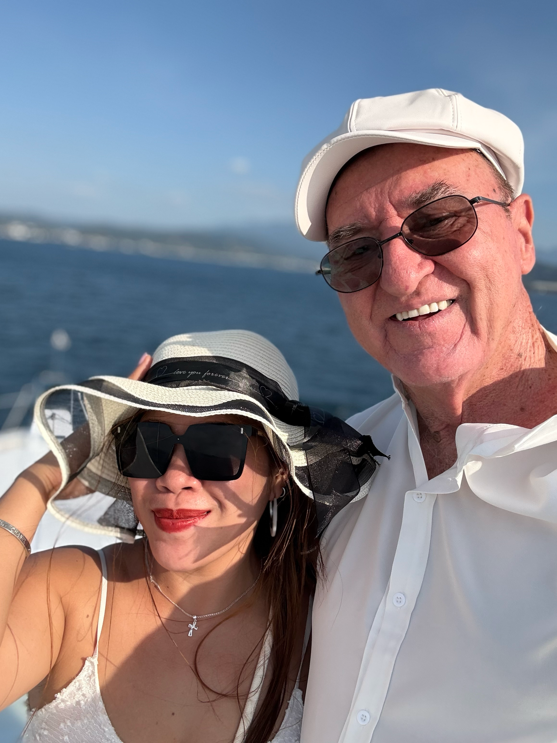 A man and a woman are posing for a picture on a boat.