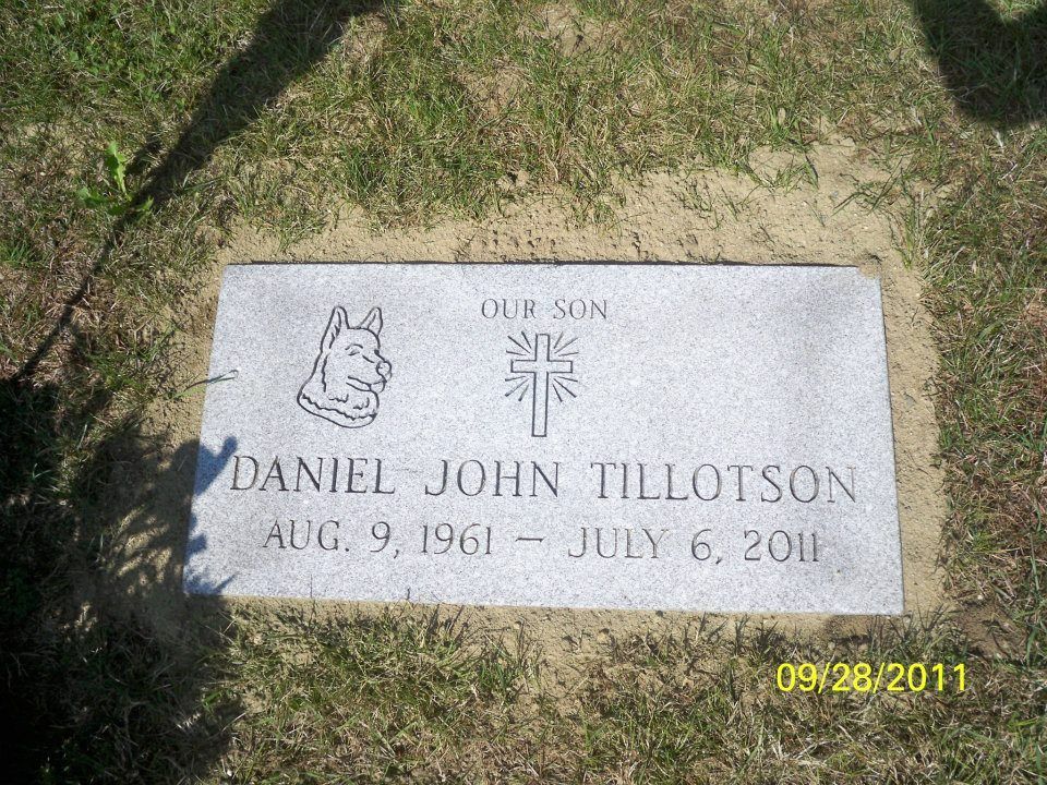 Gravestone of Daniel John Tillotson, with birth and death dates, cross, and dog silhouette.