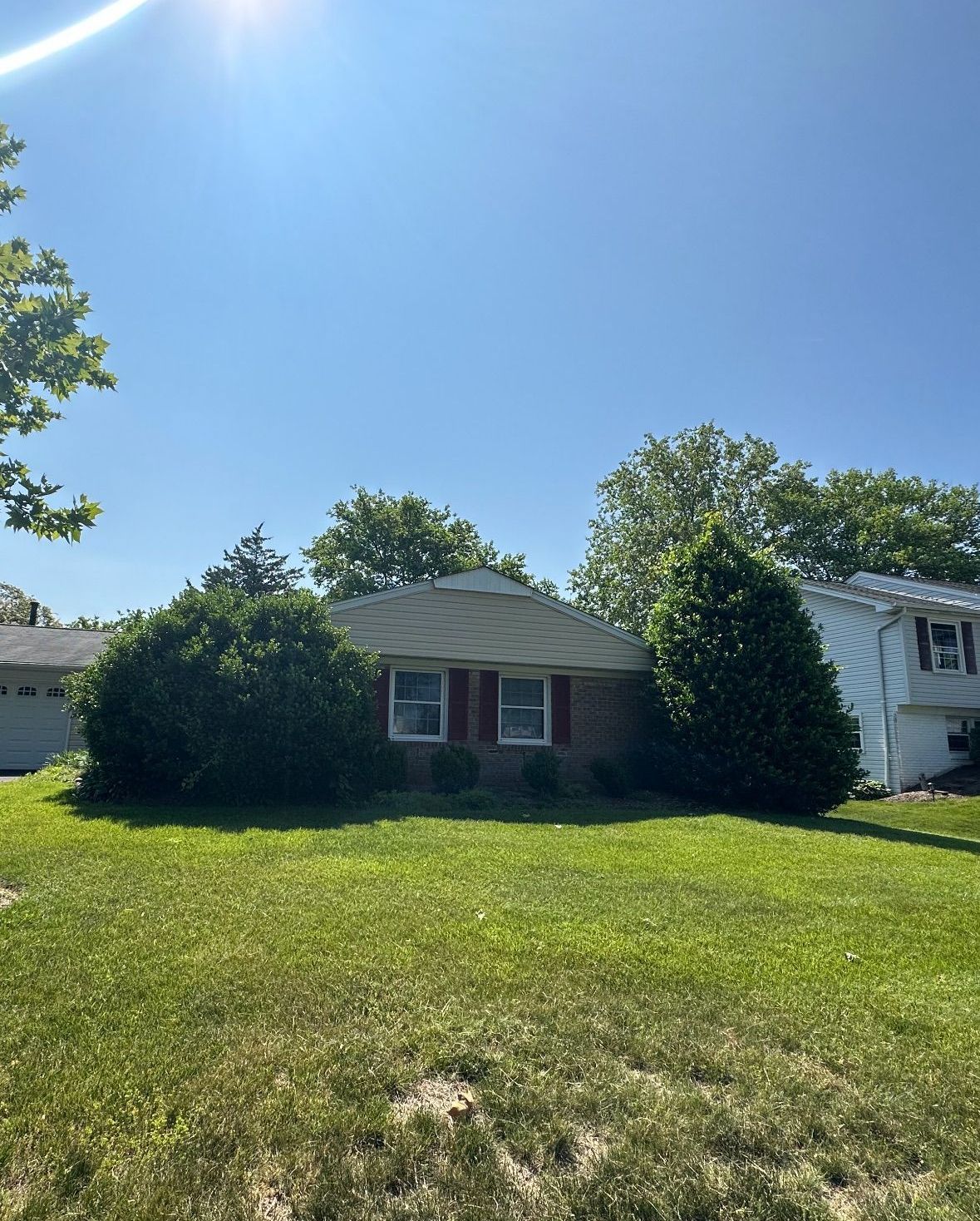 A house with a lot of grass in front of it.