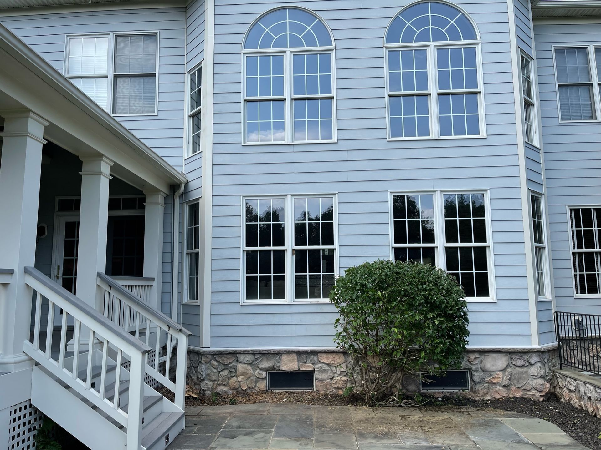 A large house with a lot of windows and stairs