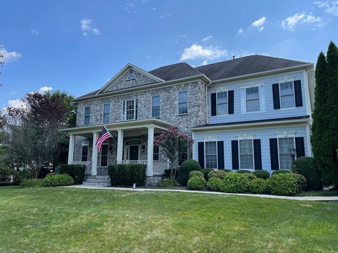 A large house with a large lawn in front of it.