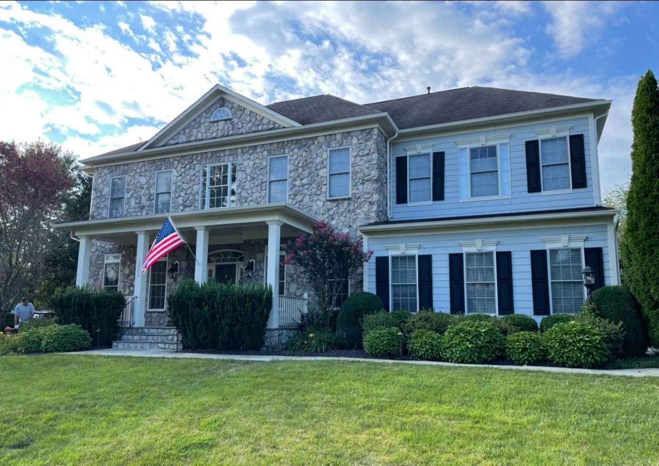 A large house with a flag on the front porch.