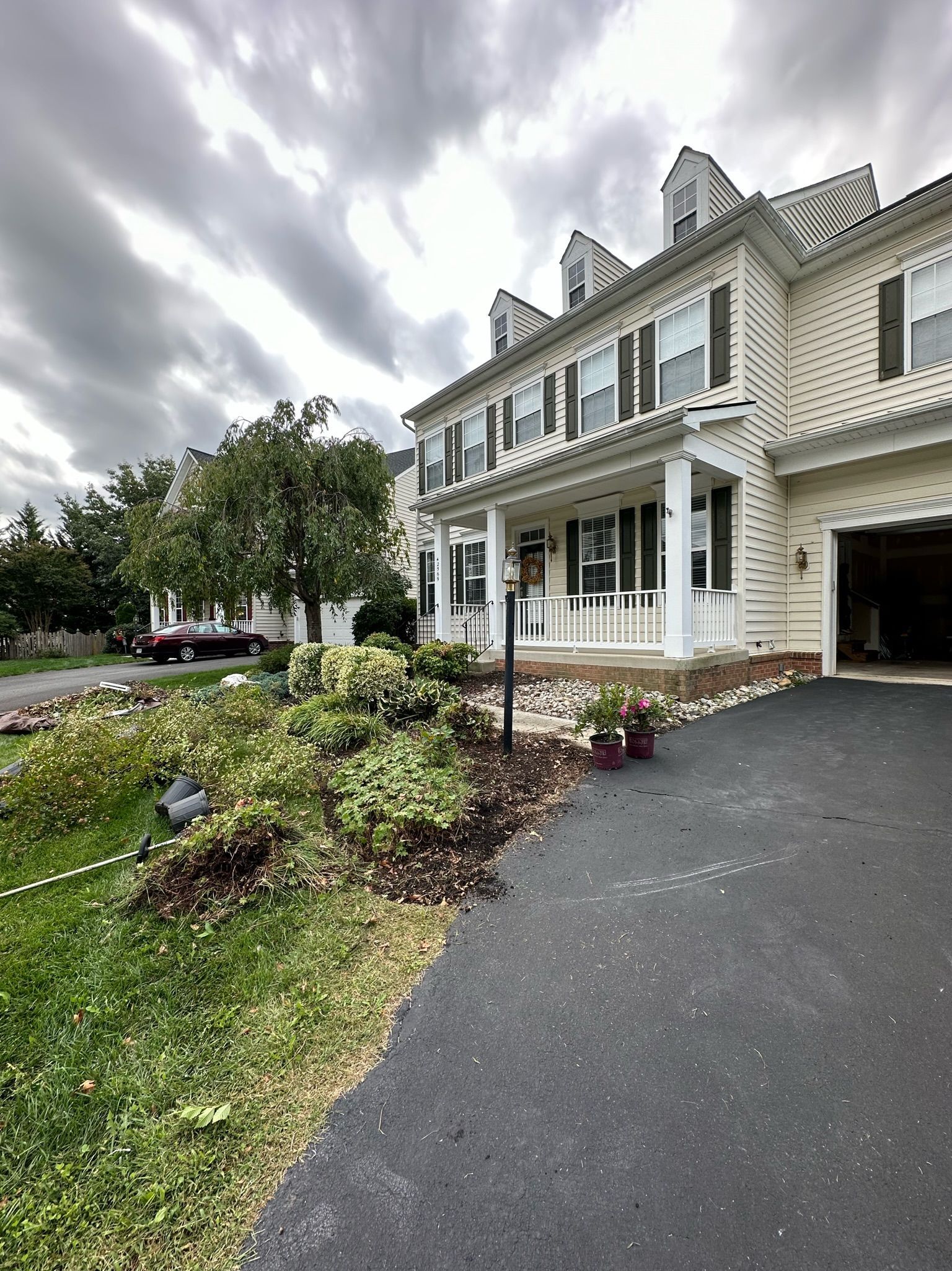 A large white house with a driveway leading to it