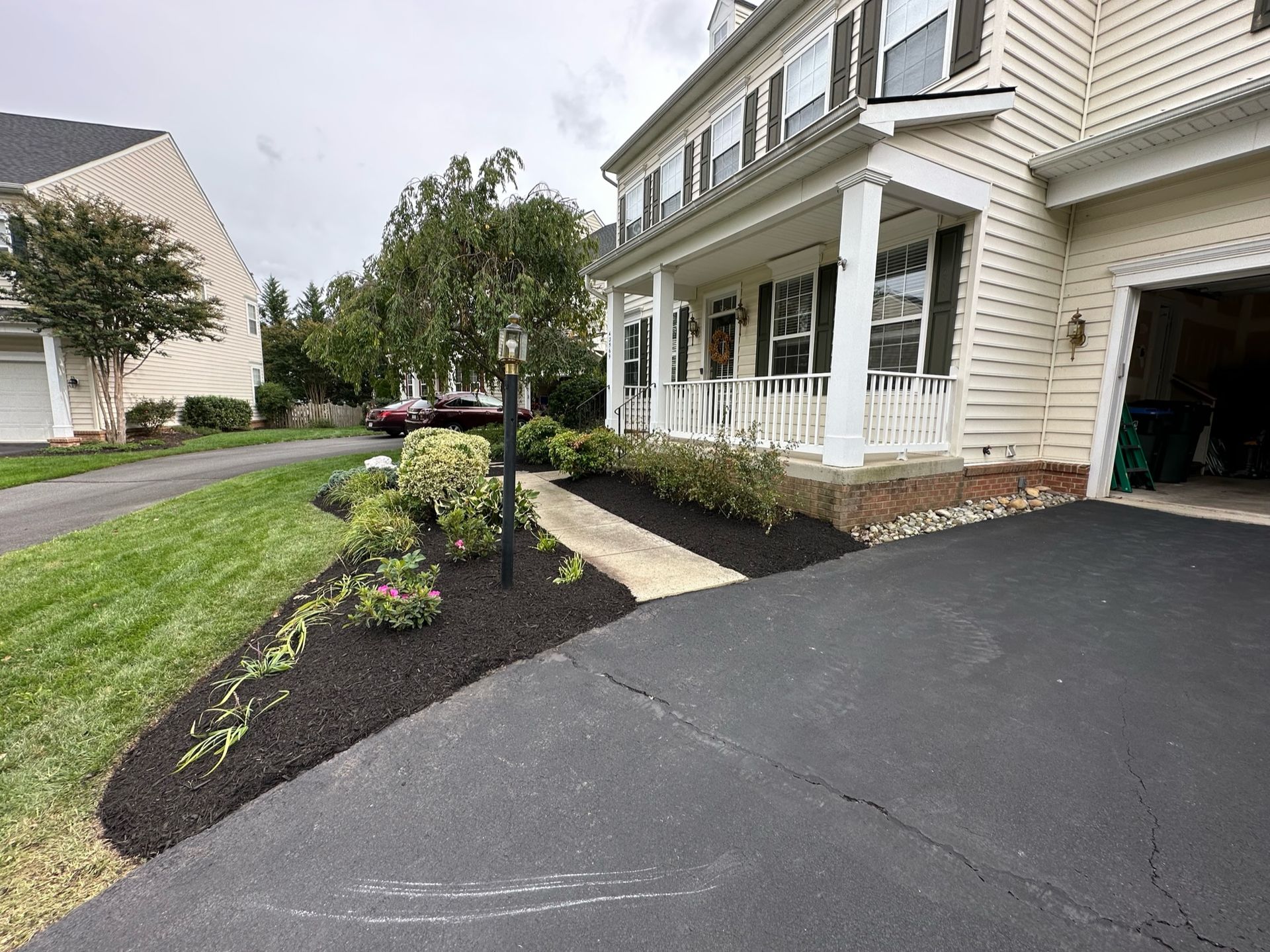 A house with a driveway leading to it and a car parked in front of it.