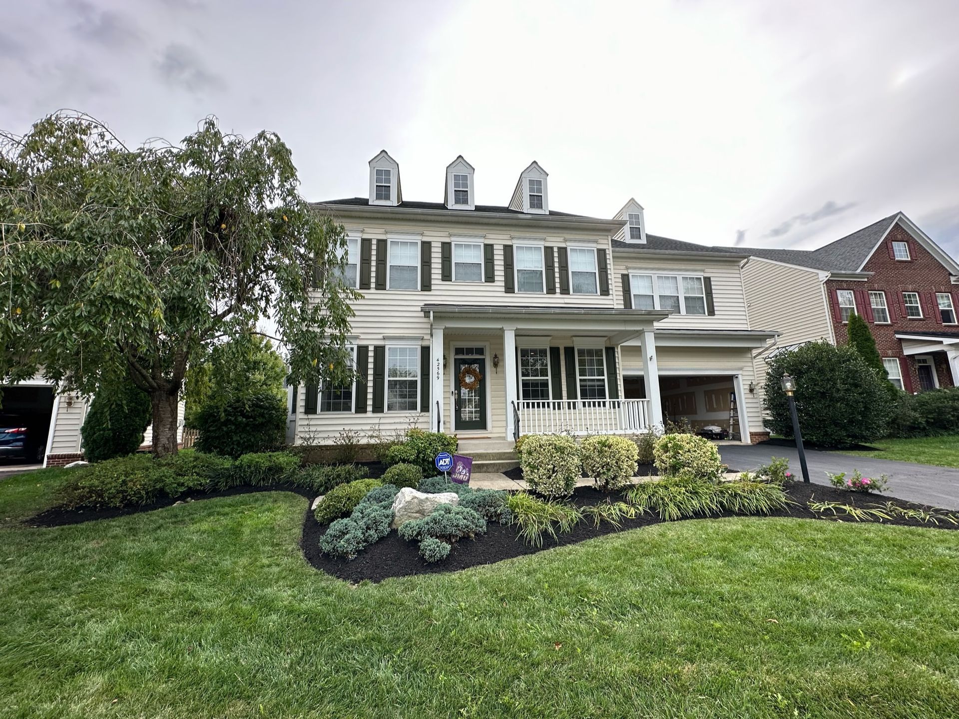 A large white house with a large lawn in front of it.