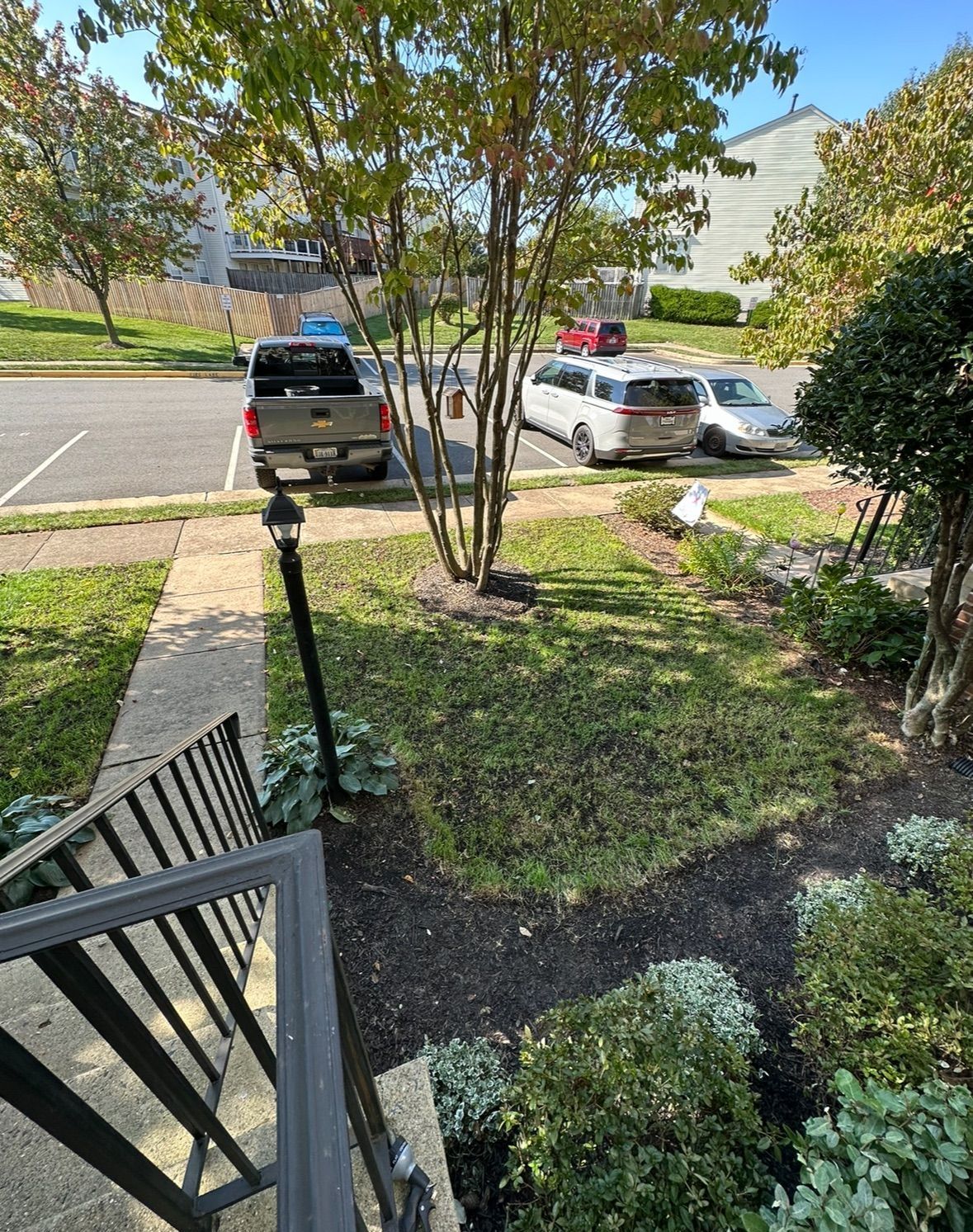 A truck is parked in a parking lot next to a staircase.