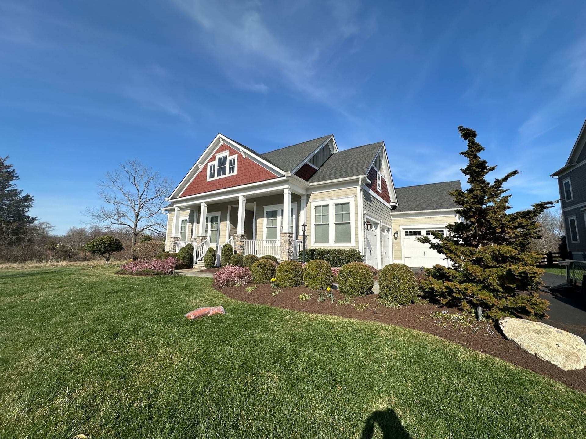 A large house with a large lawn in front of it.