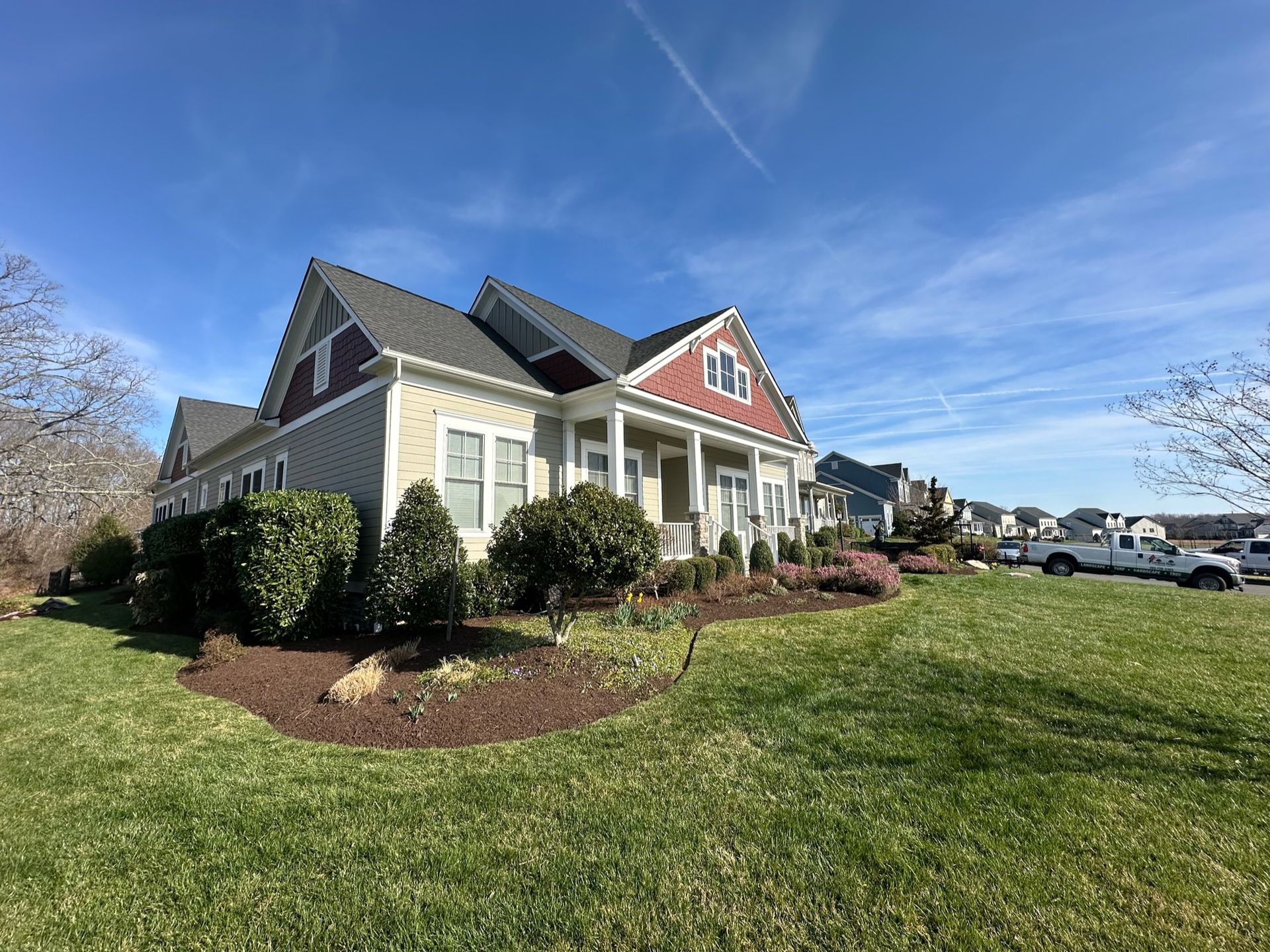 A large house with a large lawn in front of it.