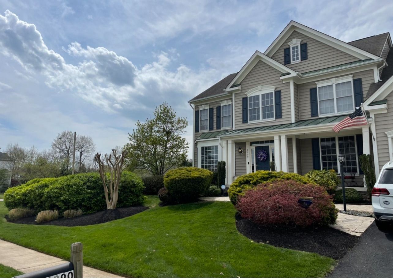 A large house with a car parked in front of it.