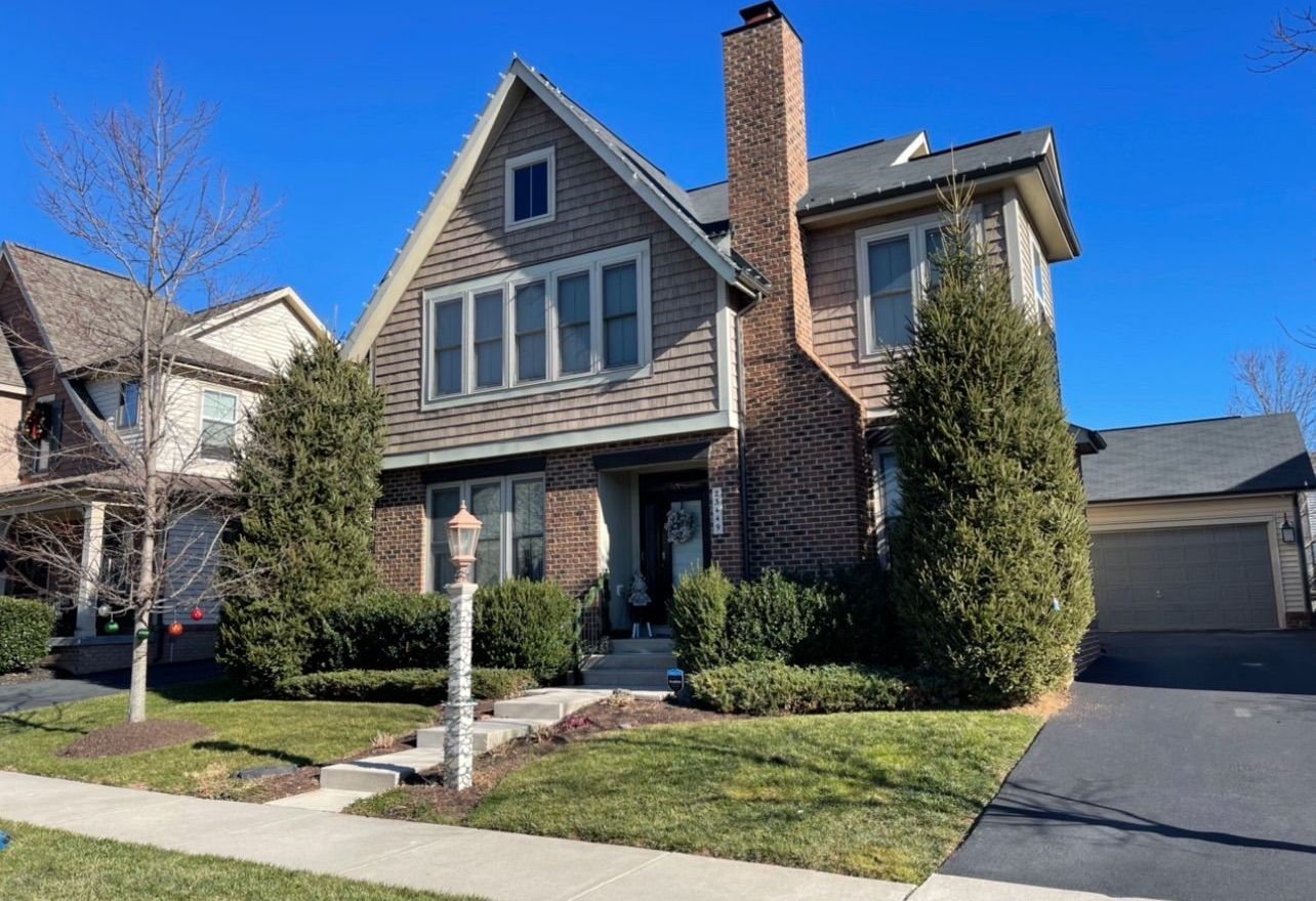 A large brick house with a chimney on top of it