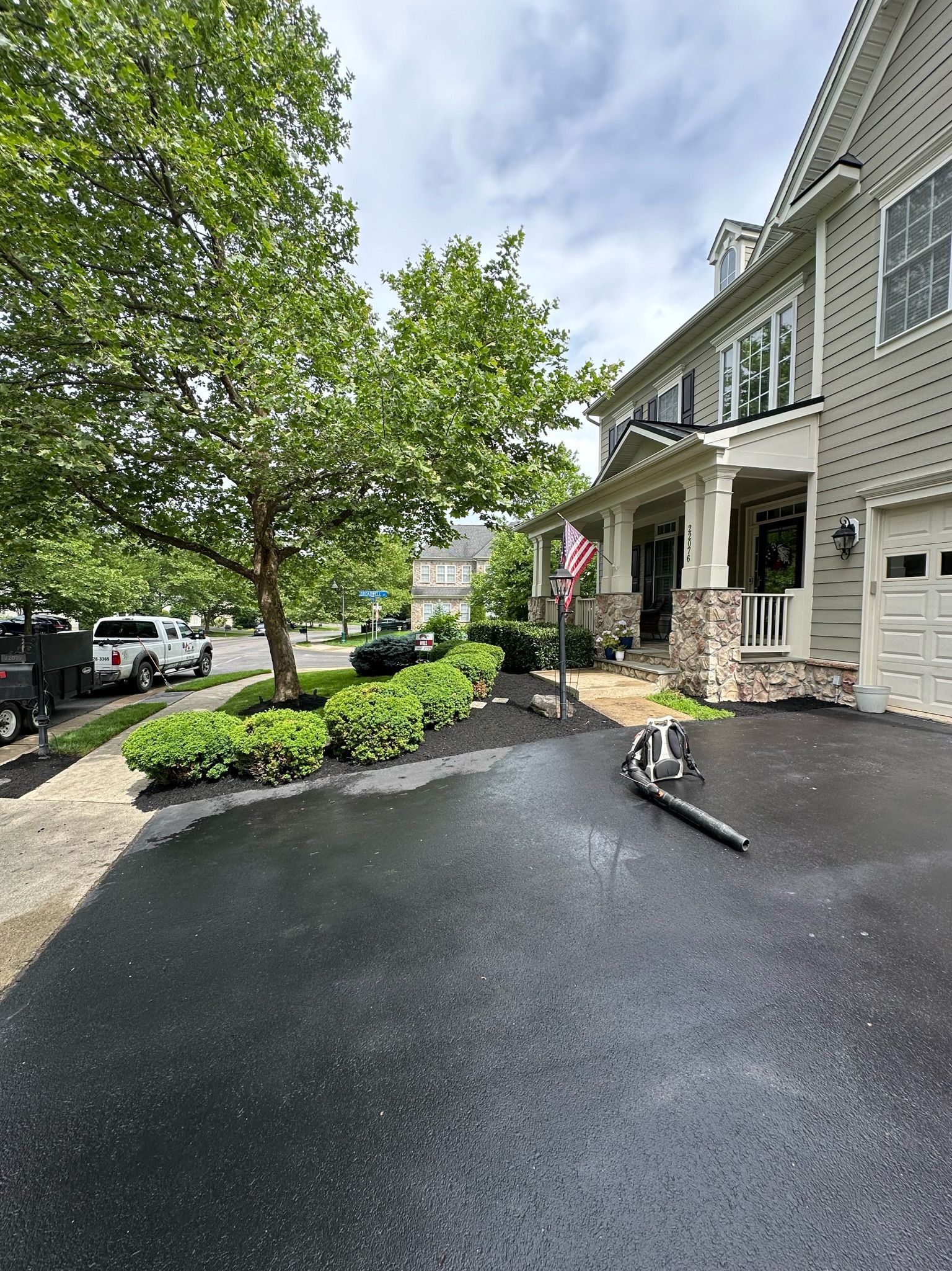 A large house with a large driveway in front of it.