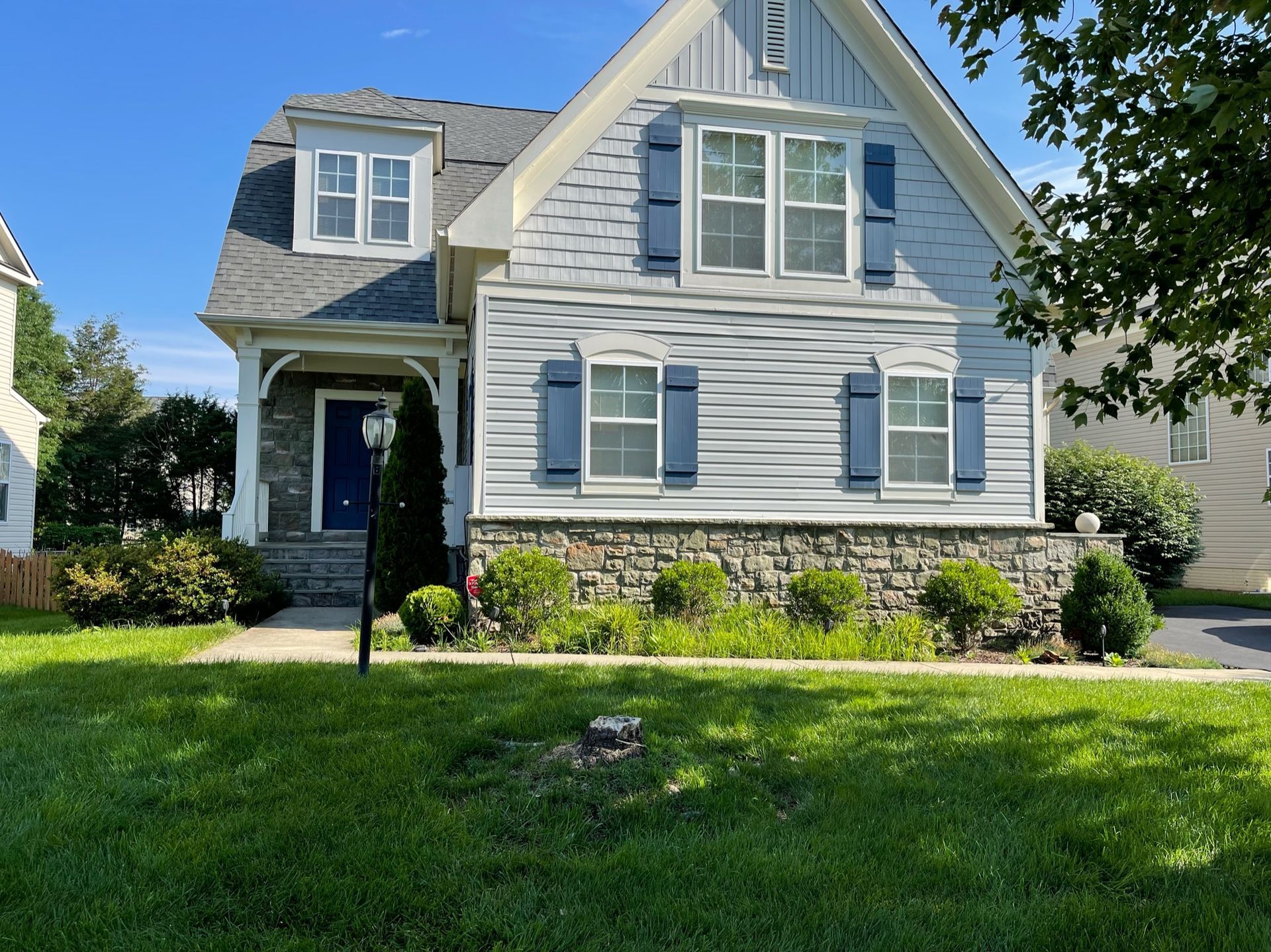 A white house with blue shutters on the windows