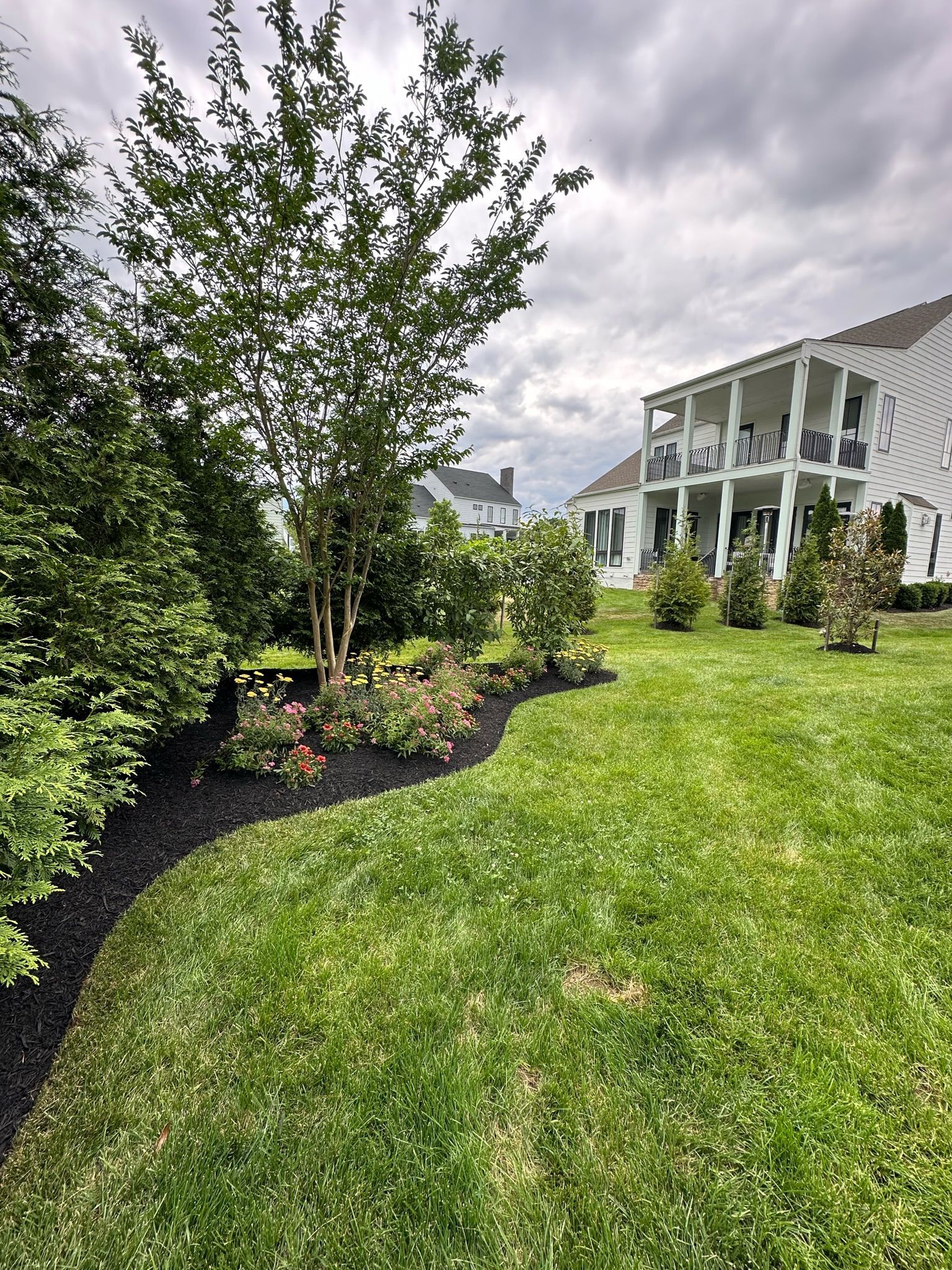 A large house with a large lawn in front of it.