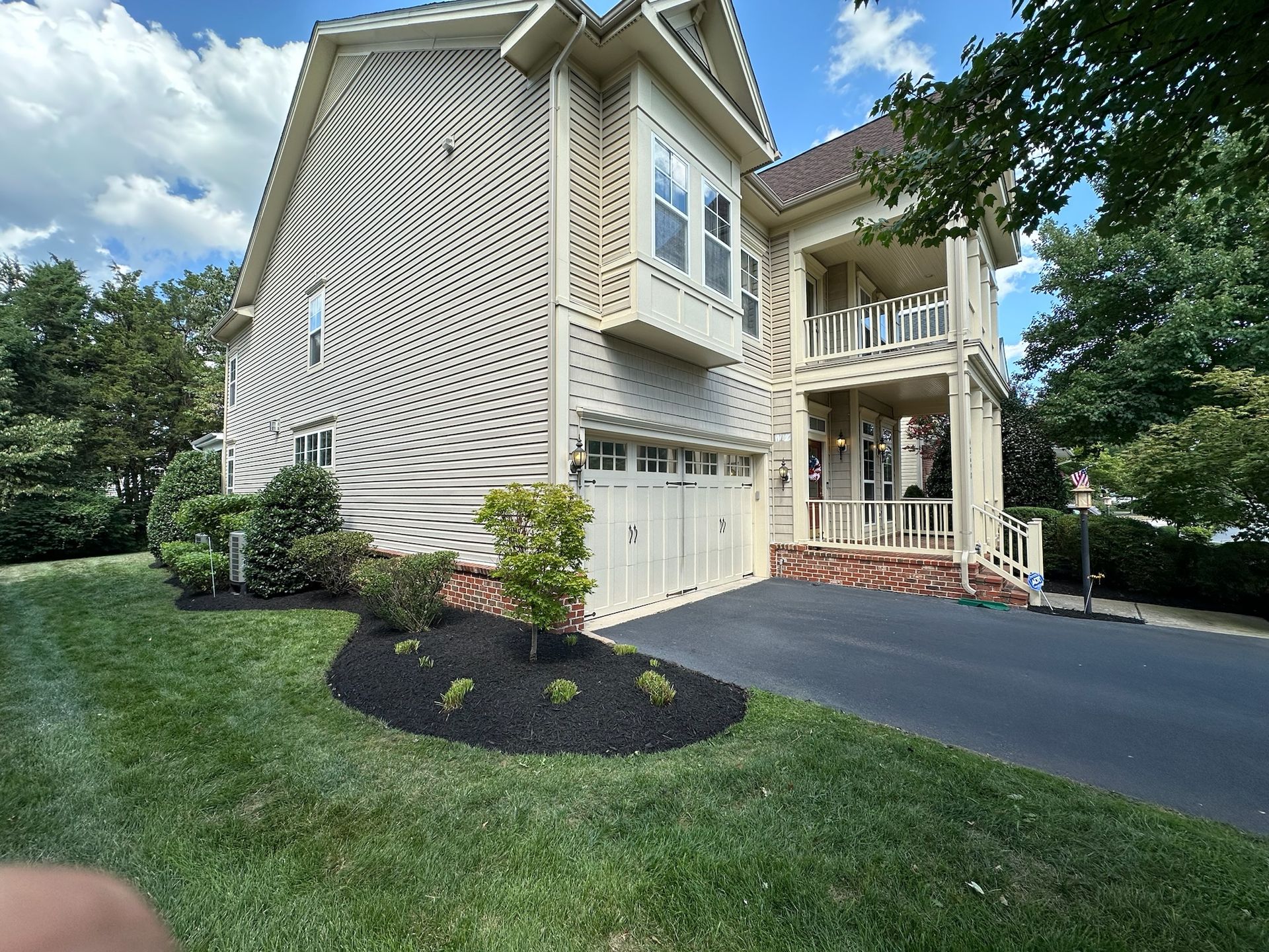 A large house with a lot of windows and a driveway