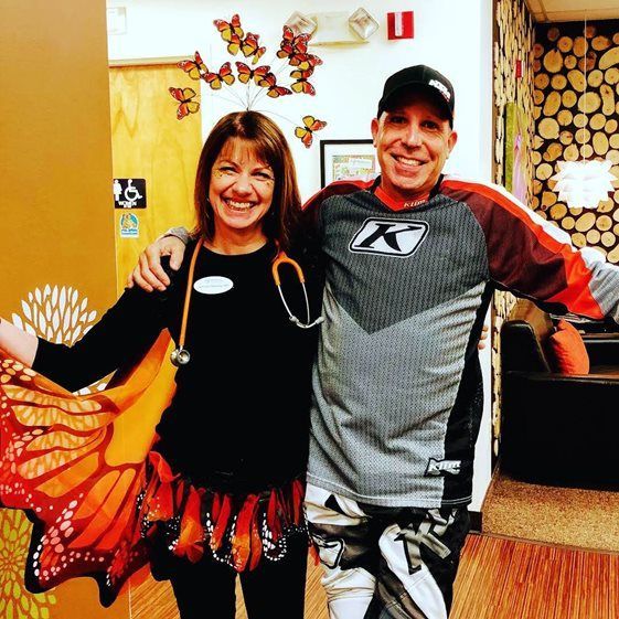 A man and a woman are posing for a picture together