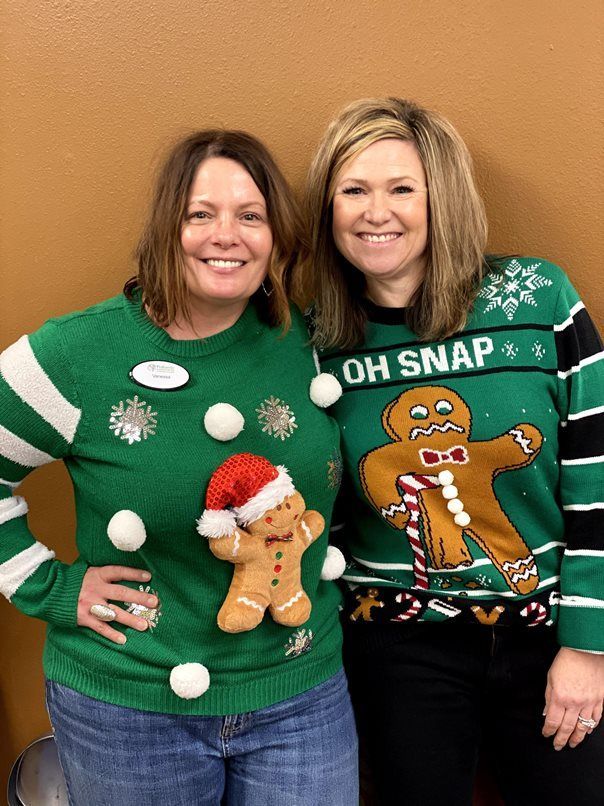 Two women in Gingerbread man sweaters
