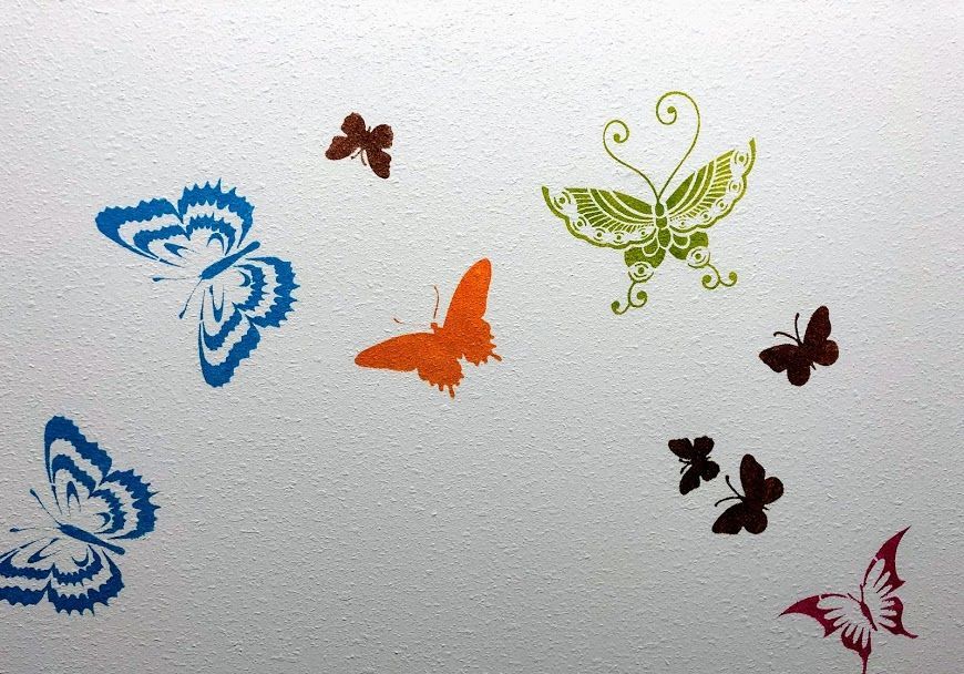 Colorful butterflies are painted on a white surface