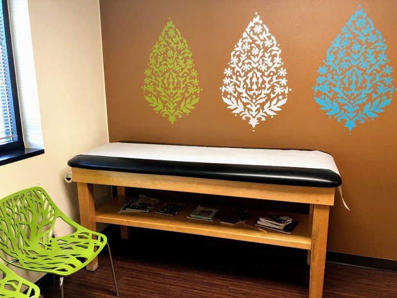 A pediatrician's office with a table and chairs