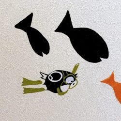 A group of fish are swimming in the water on a wall.