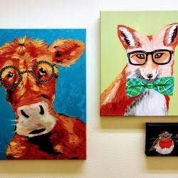 A cow wearing glasses and a fox wearing a bow tie are hanging on a wall.