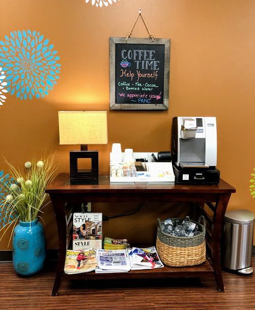 A coffee station with a sign on the wall that says coffee time
