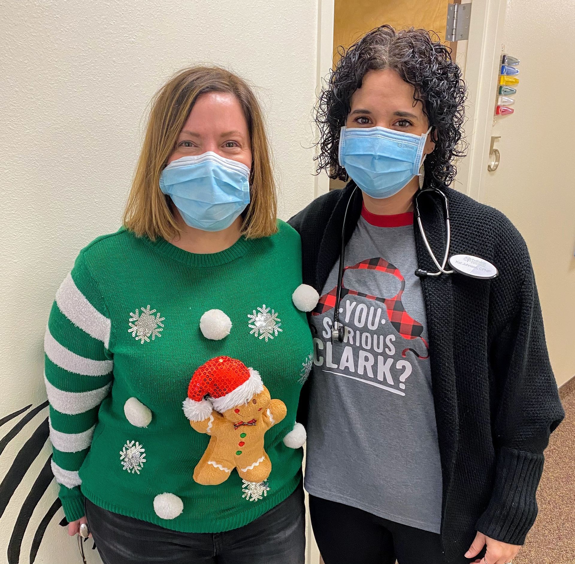 Two women wearing face masks are standing next to each other.
