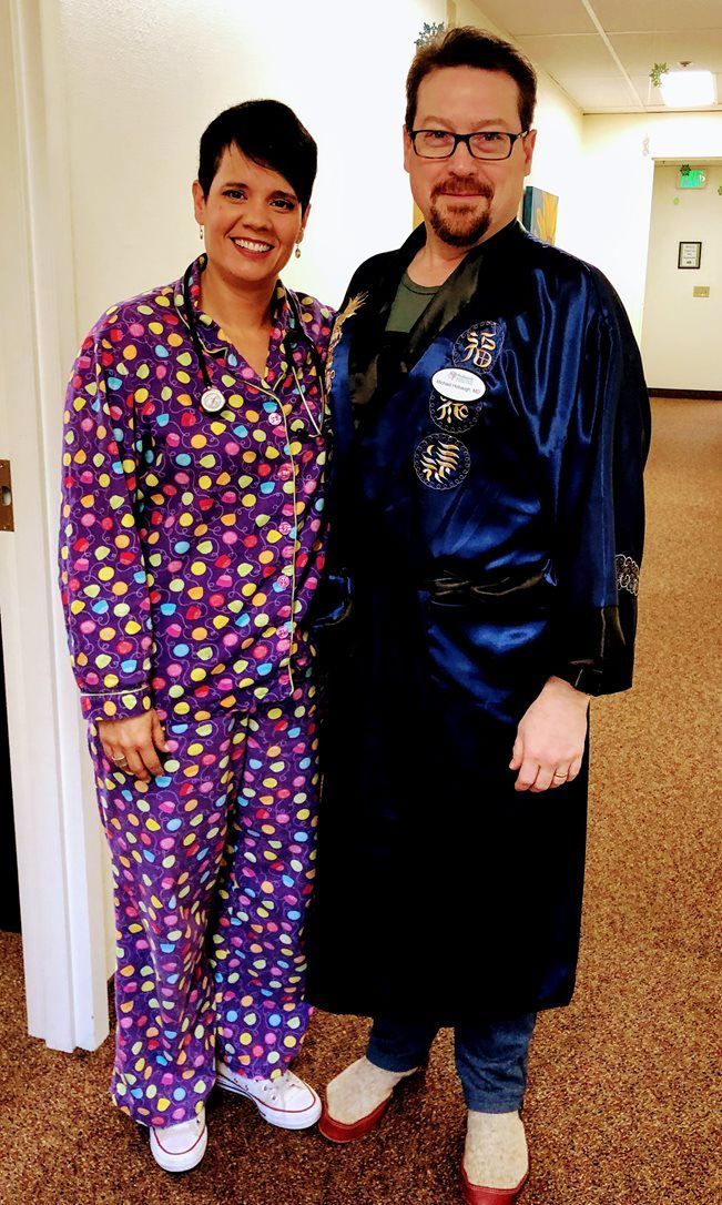 A man and a woman are standing next to each other in a hallway.
