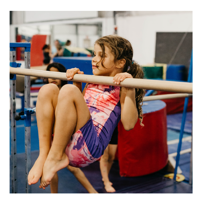 girl hanging from bar