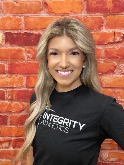 A woman wearing a black shirt that says integrity on it