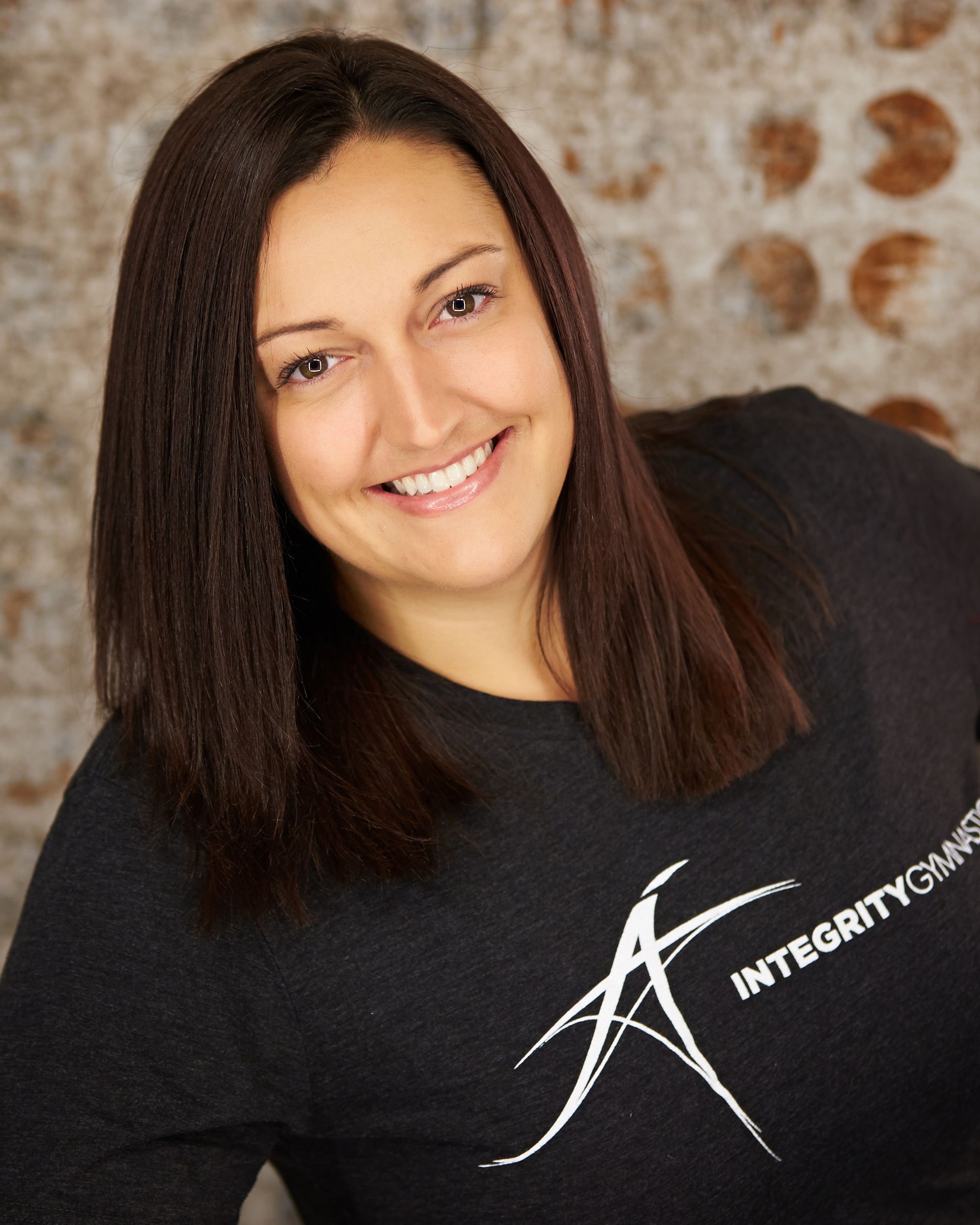 A woman wearing a black shirt that says integrity on it