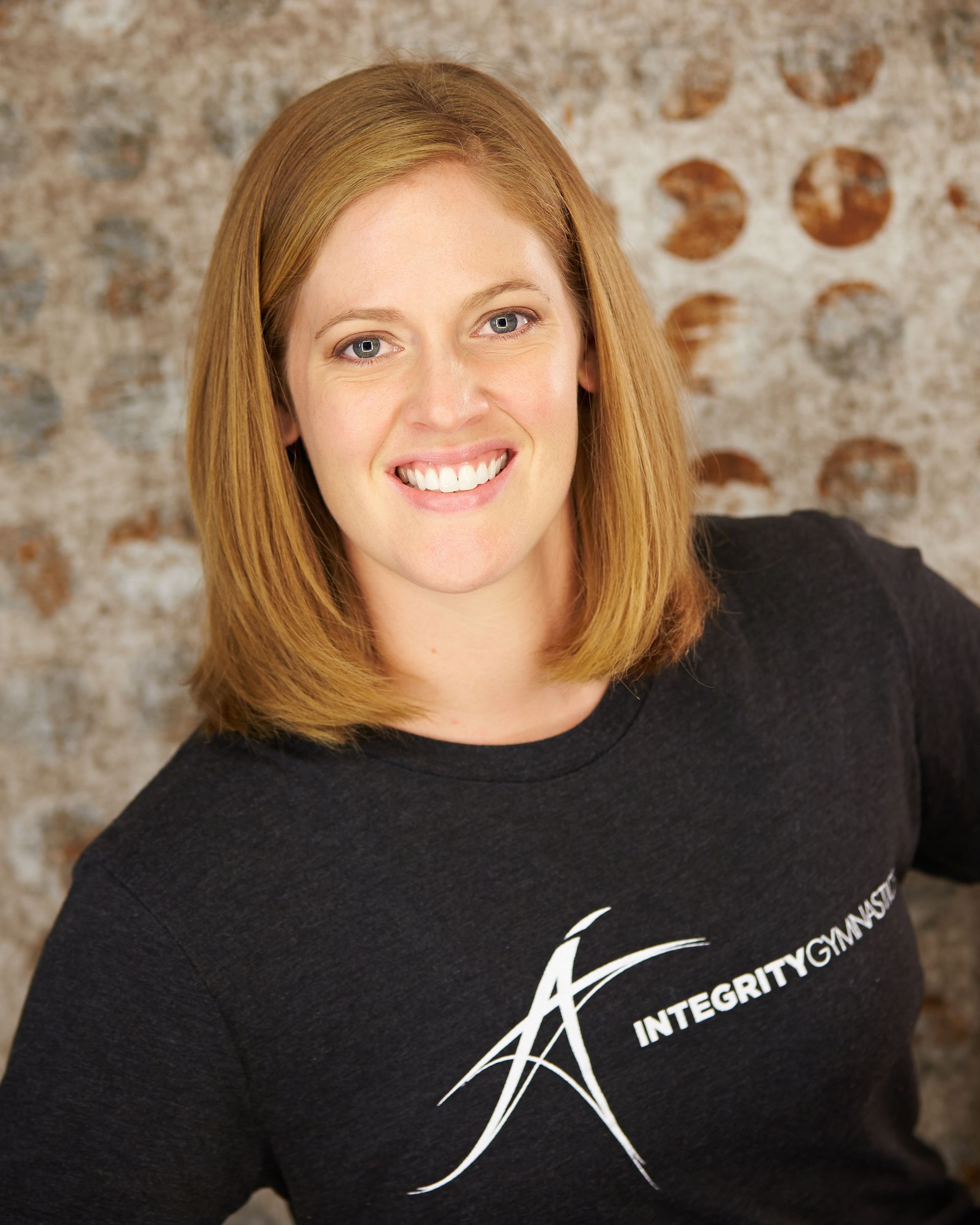 A woman wearing a black shirt that says integrity on it