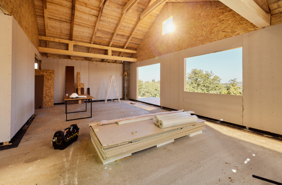 A room in a house under construction with a wooden roof.