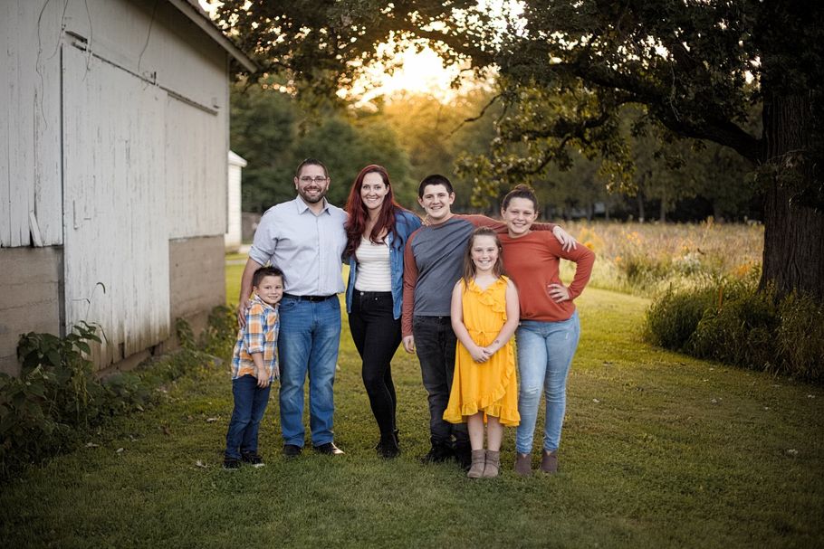 family photo with mom, dad, two daughters and two sons