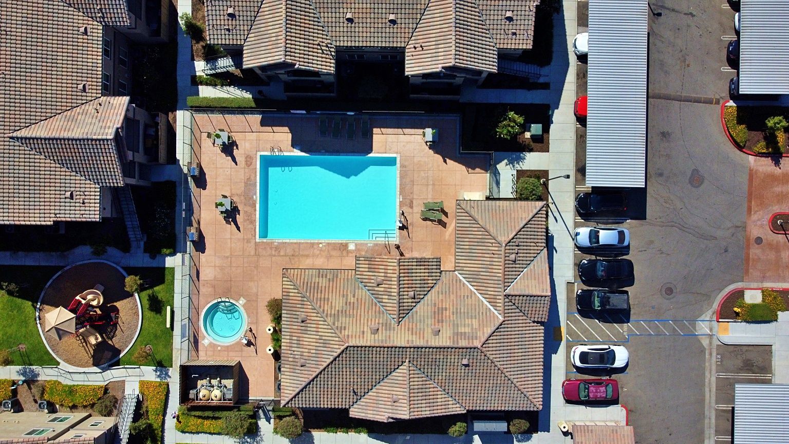 An aerial view of a swimming pool in a residential area.