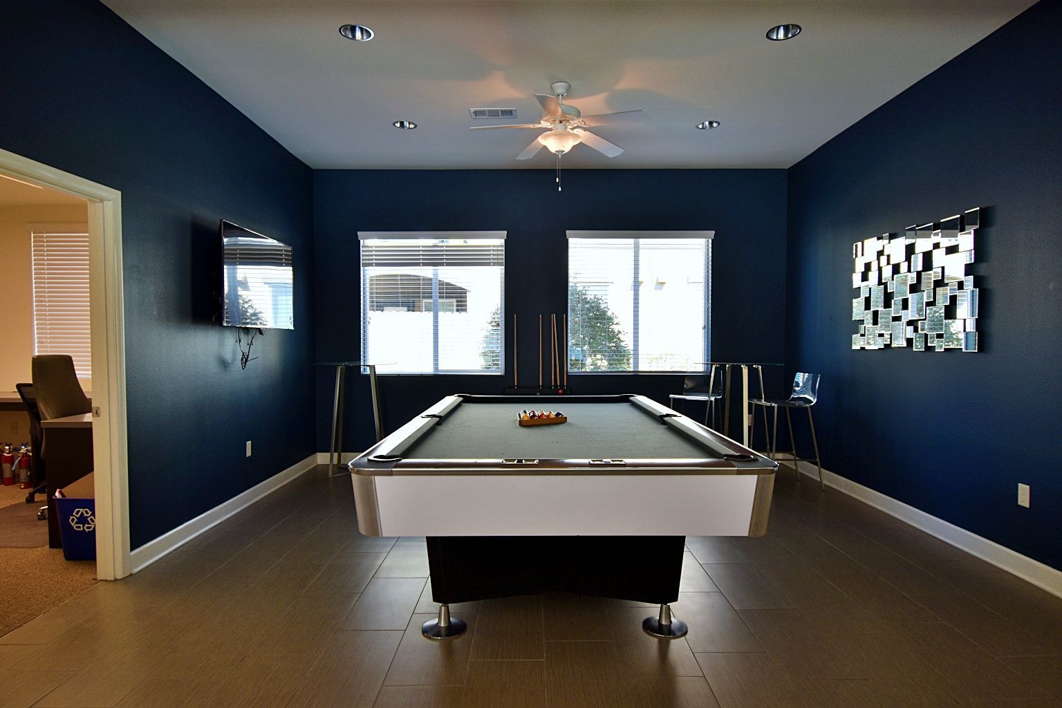 A pool table in a room with blue walls