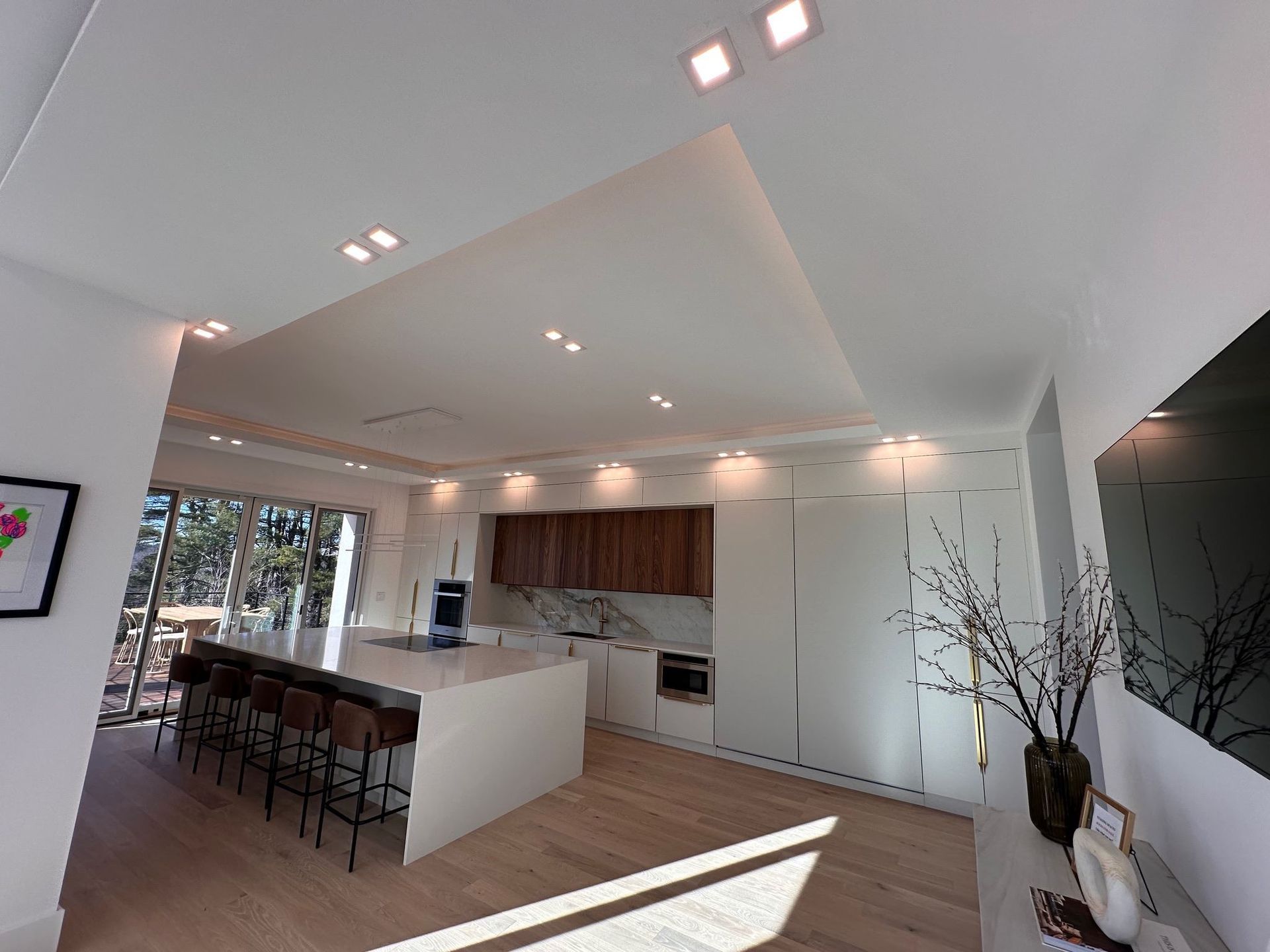 A kitchen with white cabinets and a large island in the middle.